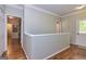 Bright hallway with hardwood floors and crisp white trim details leading to an exterior door at 230 Haynes Rd, Moreland, GA 30259