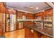 Well-equipped kitchen featuring stainless steel appliances, granite countertops, and custom cabinetry at 230 Haynes Rd, Moreland, GA 30259