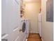 Small laundry room with a washer and dryer, storage shelves, and a small freezer at 230 Haynes Rd, Moreland, GA 30259