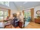 Bright living room features a fireplace, hardwood floors, and large windows offering scenic views at 230 Haynes Rd, Moreland, GA 30259