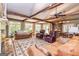 Spacious living room featuring exposed beams, fireplace, and large windows at 230 Haynes Rd, Moreland, GA 30259