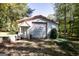 Exterior shot of a spacious outbuilding with a roll-up door and brick pavers at 230 Haynes Rd, Moreland, GA 30259