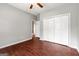 A bedroom with laminate floors, closet, and a view to the hallway at 210 Brittany Chase, Fayetteville, GA 30214