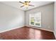 A bright bedroom with a ceiling fan and a window providing plenty of natural light at 210 Brittany Chase, Fayetteville, GA 30214