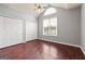 Bedroom featuring two closets, laminate floors and high ceiling with large arched window at 210 Brittany Chase, Fayetteville, GA 30214