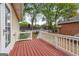 Enjoy outdoor living on this red painted deck overlooking a landscaped backyard at 210 Brittany Chase, Fayetteville, GA 30214