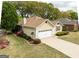 Charming single-Gathering home with a well-manicured lawn, attached garage, and mature landscaping at 210 Brittany Chase, Fayetteville, GA 30214