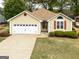 Front exterior view of a charming home with an attached garage, and mature landscaping at 210 Brittany Chase, Fayetteville, GA 30214