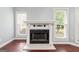 Close up on the traditional fireplace, flanked by windows with hardwood flooring in the living room at 210 Brittany Chase, Fayetteville, GA 30214