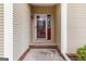Covered front entry featuring a decorative glass front door and sidelight with a brick step at 210 Brittany Chase, Fayetteville, GA 30214