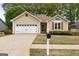 Charming single-story home featuring a two-car garage, well-kept lawn, and inviting curb appeal at 210 Brittany Chase, Fayetteville, GA 30214