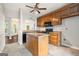 Traditional kitchen features wood cabinets, black appliances, an island, and a ceiling fan at 210 Brittany Chase, Fayetteville, GA 30214