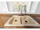 A close-up of the kitchen sink showcasing the stainless-steel faucet and a view of the bay window at 210 Brittany Chase, Fayetteville, GA 30214