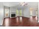 Bright living room with hardwood floors, a fireplace, large windows, and a ceiling fan at 210 Brittany Chase, Fayetteville, GA 30214