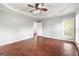 Light filled main bedroom featuring tray ceilings, ceiling fan, and wood-look floors at 210 Brittany Chase, Fayetteville, GA 30214