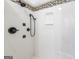 Close up of shower featuring rainfall and handheld shower heads, and marble bench at 210 Brittany Chase, Fayetteville, GA 30214