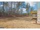 A partially wooded lot featuring an elevated wood deck with brick foundation at 7260 Eton Ln, Locust Grove, GA 30248