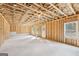 Unfinished basement awaiting customization and personalization with studded walls and windows at 7260 Eton Ln, Locust Grove, GA 30248