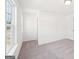 Bright bedroom with neutral carpet, white walls, and a window for natural light at 7260 Eton Ln, Locust Grove, GA 30248