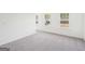 Bedroom featuring neutral carpet, three windows, and ample natural light at 7260 Eton Ln, Locust Grove, GA 30248