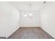 Clean, light-filled dining room with hardwood floors and a modern chandelier at 7260 Eton Ln, Locust Grove, GA 30248