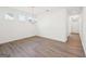 Elegant dining room boasting wood-look floors, chandelier, and bright light at 7260 Eton Ln, Locust Grove, GA 30248