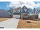 Charming blue two-story home with stone accents and attached two-car garage at 7260 Eton Ln, Locust Grove, GA 30248