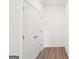 Hallway with closet doors and wood flooring at 7260 Eton Ln, Locust Grove, GA 30248