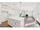 Modern kitchen with white cabinets, stainless steel appliances, and a large kitchen island at 7260 Eton Ln, Locust Grove, GA 30248
