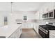 Stylish kitchen with white cabinets, stainless steel appliances, and modern countertops at 7260 Eton Ln, Locust Grove, GA 30248