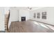 Bright living room featuring a fireplace, large windows, and hardwood floors at 7260 Eton Ln, Locust Grove, GA 30248