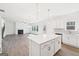 Open floor plan with kitchen island and view of the fireplace in the living room at 7260 Eton Ln, Locust Grove, GA 30248
