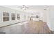 Bright living room with large windows, wood floors, and an open floor plan to the kitchen at 7260 Eton Ln, Locust Grove, GA 30248