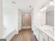 Elegant bathroom featuring dual sinks, a separate shower, soaking tub, and wood-look flooring at 7260 Eton Ln, Locust Grove, GA 30248