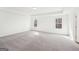 Spacious main bedroom featuring neutral carpet, tray ceiling and an abundance of natural light at 7260 Eton Ln, Locust Grove, GA 30248