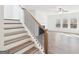 Staircase leading into a living space with a fireplace and big windows at 7260 Eton Ln, Locust Grove, GA 30248