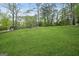 Expansive grassy backyard with mature trees, creating a serene and private outdoor space at 3387 Oak Dr, Lawrenceville, GA 30044