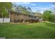 Spacious backyard showcasing lush green grass, a brick facade, and ample space at 3387 Oak Dr, Lawrenceville, GA 30044