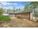 Spacious backyard with brick house and detached garage, perfect for outdoor activities at 3387 Oak Dr, Lawrenceville, GA 30044