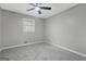 This bedroom features neutral walls, carpet, a ceiling fan, and one window at 3387 Oak Dr, Lawrenceville, GA 30044
