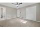 This bedroom features neutral walls, carpet, a ceiling fan, closet, and an ensuite bathroom entrance at 3387 Oak Dr, Lawrenceville, GA 30044