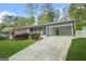 A home showcasing a covered carport and landscaped front yard, blending convenience with curb appeal at 3387 Oak Dr, Lawrenceville, GA 30044