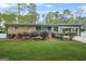 Charming brick home featuring a well-manicured lawn and an inviting covered carport at 3387 Oak Dr, Lawrenceville, GA 30044