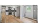 Modern kitchen boasts stainless steel appliances, white cabinetry, and hardwood flooring at 3387 Oak Dr, Lawrenceville, GA 30044