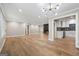 An open-concept living room flows into a modern kitchen with stainless steel appliances and hardwood flooring at 3387 Oak Dr, Lawrenceville, GA 30044