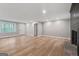 Bright living room featuring hardwood floors, a modern door, and freshly painted walls at 3387 Oak Dr, Lawrenceville, GA 30044