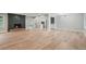 Sunlit living room with modern flooring, a brick fireplace, and neutral walls at 3387 Oak Dr, Lawrenceville, GA 30044