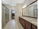 Bright bathroom featuring double vanity with granite countertops and a view to a walk-in closet at 270 Blue Point Pkwy, Fayetteville, GA 30215