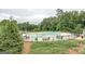 Community pool surrounded by tables, chairs, lounge chairs, and greenery, providing a great place to relax at 270 Blue Point Pkwy, Fayetteville, GA 30215