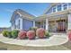 Inviting front entrance featuring stone accents, white columns, and a beautiful wooden front door at 270 Blue Point Pkwy, Fayetteville, GA 30215